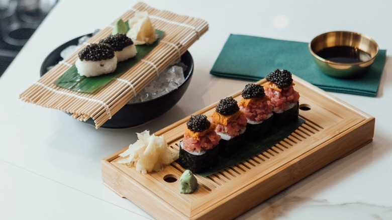 Two sushi and caviar dishes on bamboo