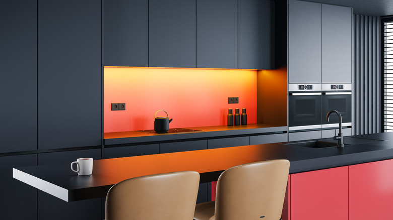 Orange-red kitchen backsplash with dark counters and cabinets