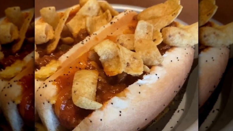 Fritos and sloppy Joe meat on a hot dog