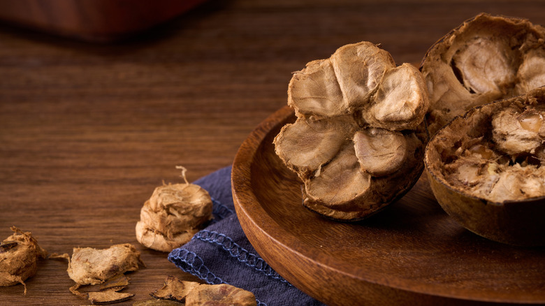 Monk fruit cut up in wooden bowl