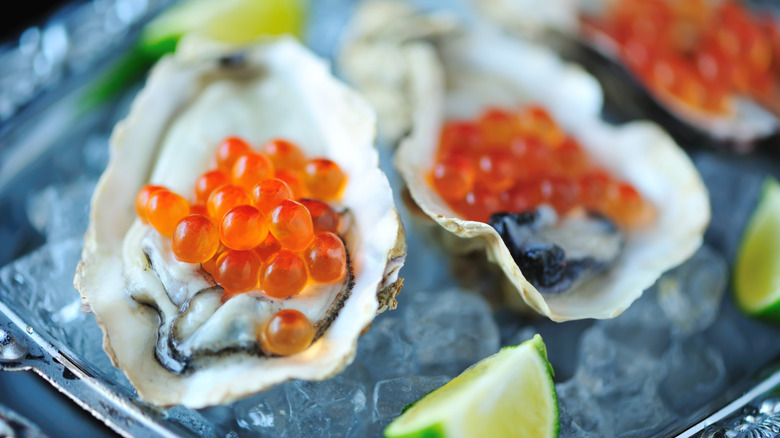 Close-up of oysters topped with caviar on ice