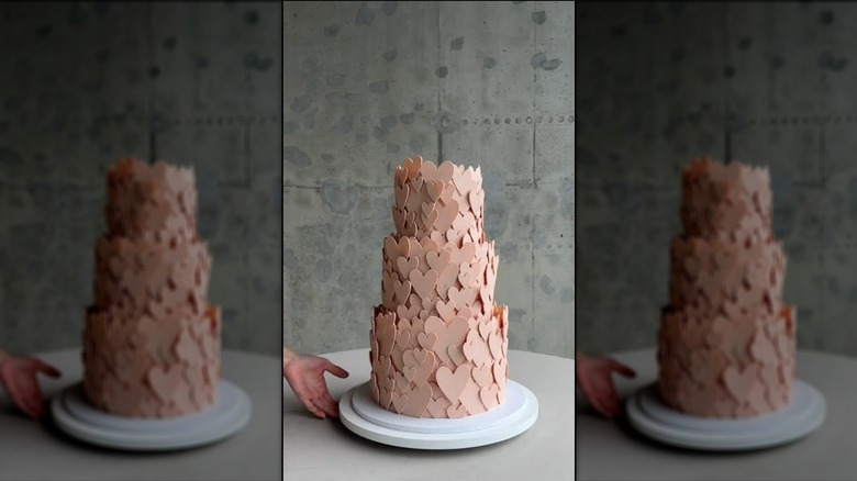 Three-tier cake covered in chocolate hearts