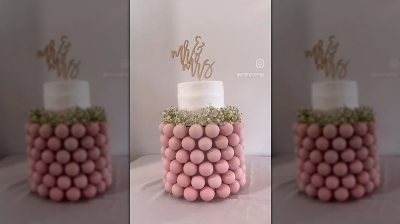 Wedding cake pop display with topper