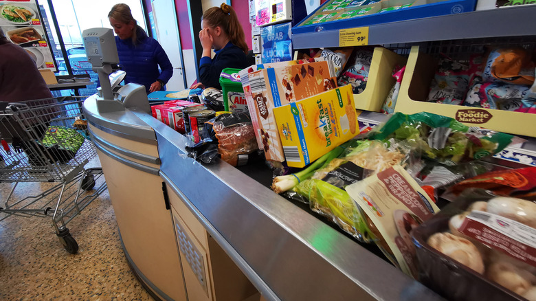 Checkout counter at Aldi with customer paying.