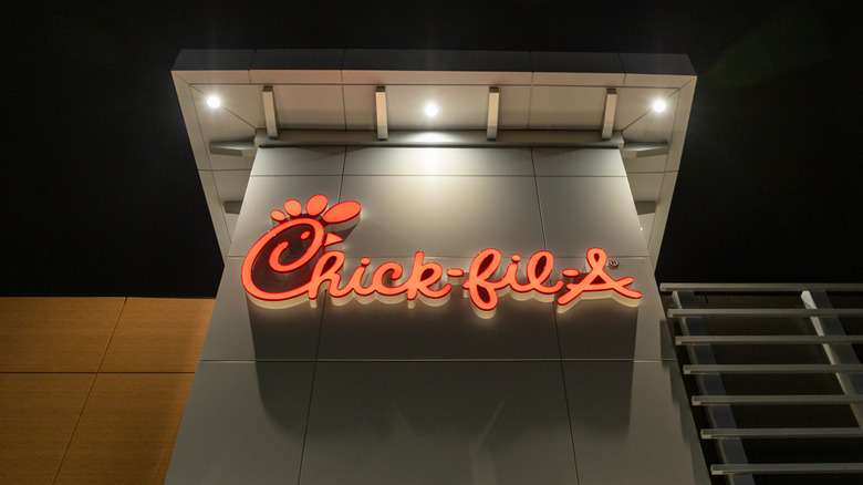 Chick-fil-A sign on building at night