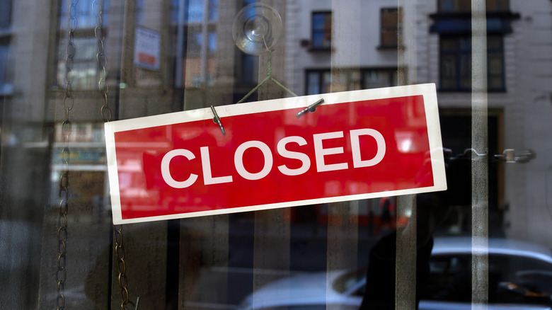 Red closed sign on glass window