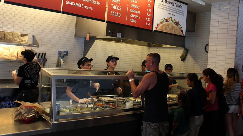 People ordering food at a Chipotle restaurant