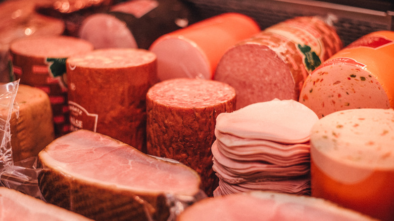Deli meat stacked in refrigerated cabinet