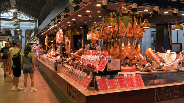 Busy deli counter with various meat