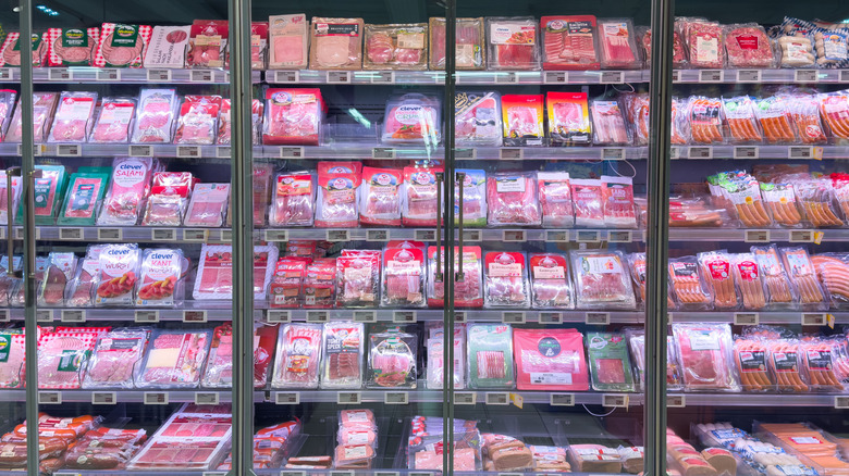 Packaged deli meat in refrigerator at grocery store