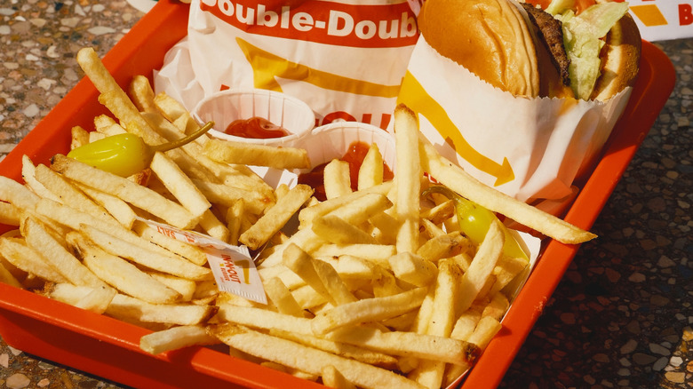 Close up of ketchup and chili peppers with fries