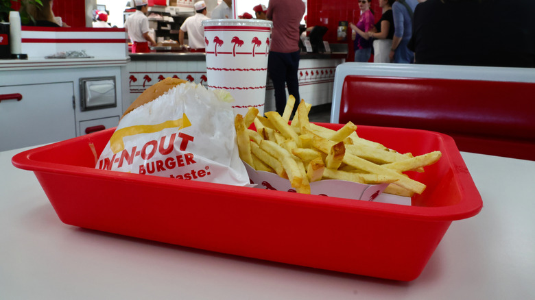 View of In-N-Out fries on a table in the restaurant with the order counter in the background