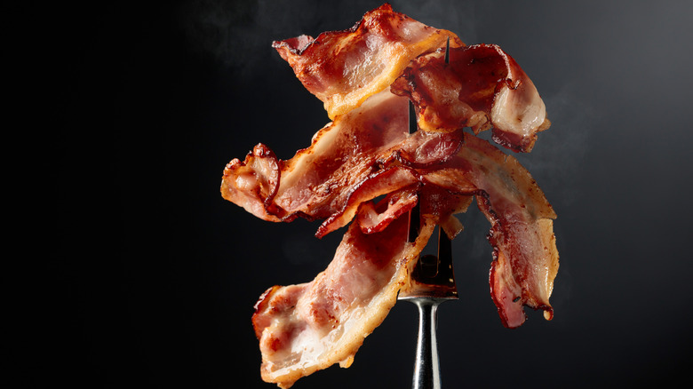 Fried bacon on a fork