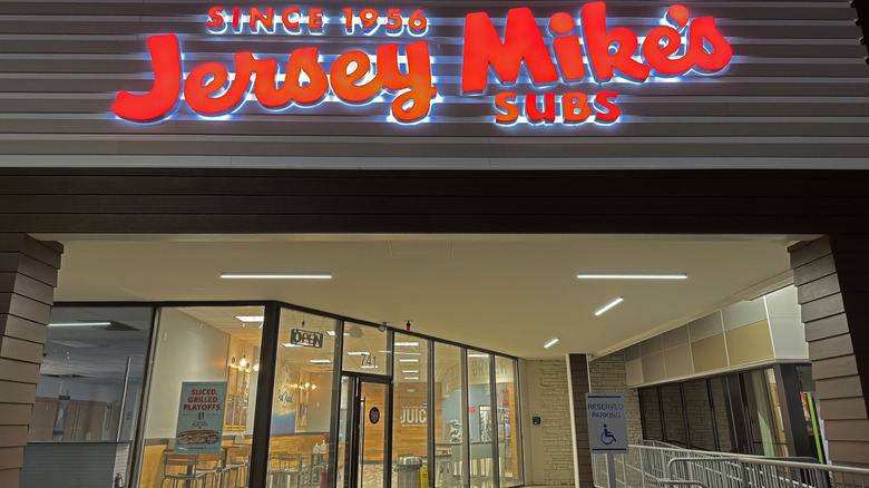 Jersey Mikes exterior at night with neon sign