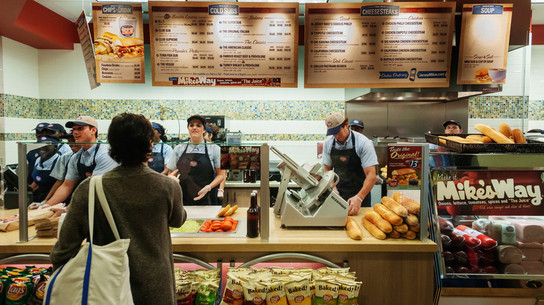 Customer orders inside a Jersey Mikes sandwich shop