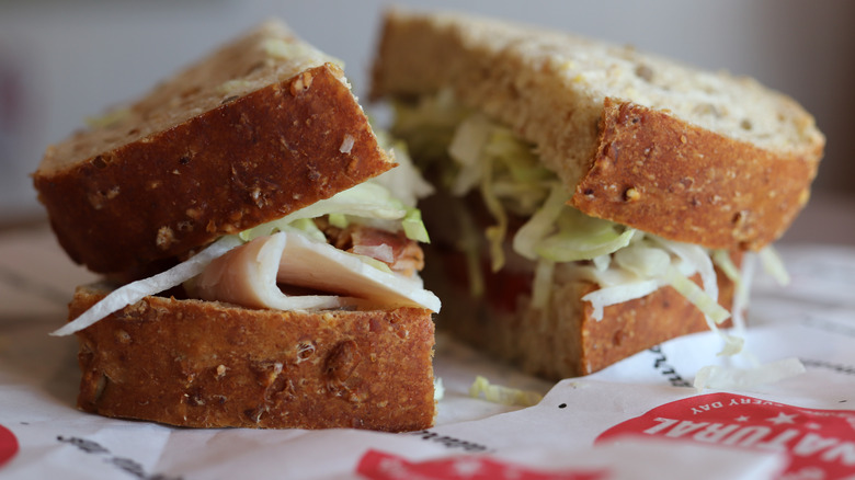 Close up of a Jimmy Johns sandwich sliced down the middle with wheat bread