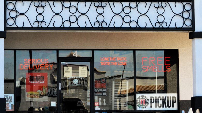 Neon signs in the windows at Jimmy Johns
