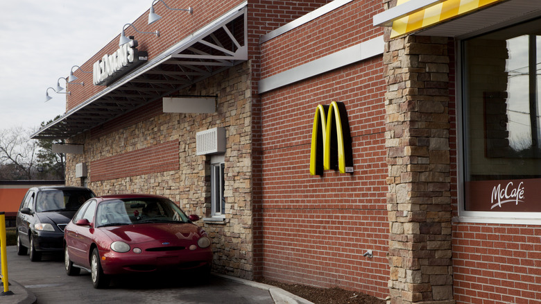 An outside shot showing two cars using the McDonald's drive-thru service