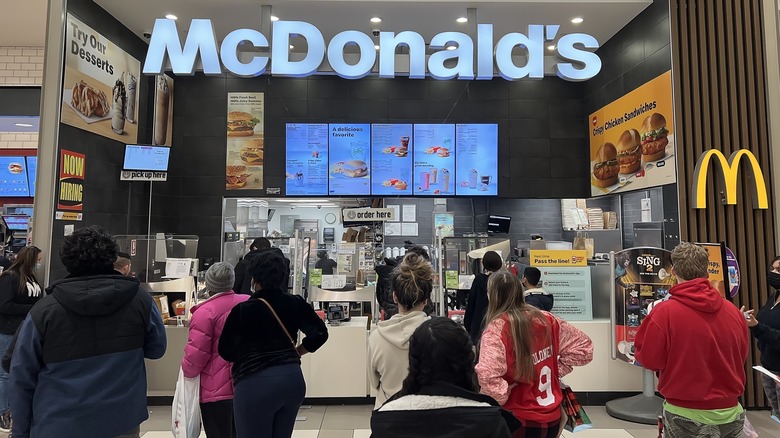A busy McDonald's counter, with people queuing up to get their food