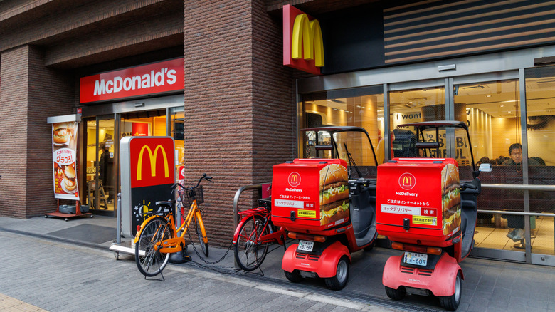 A couple of McDelivery carts outside of a McDonald's location