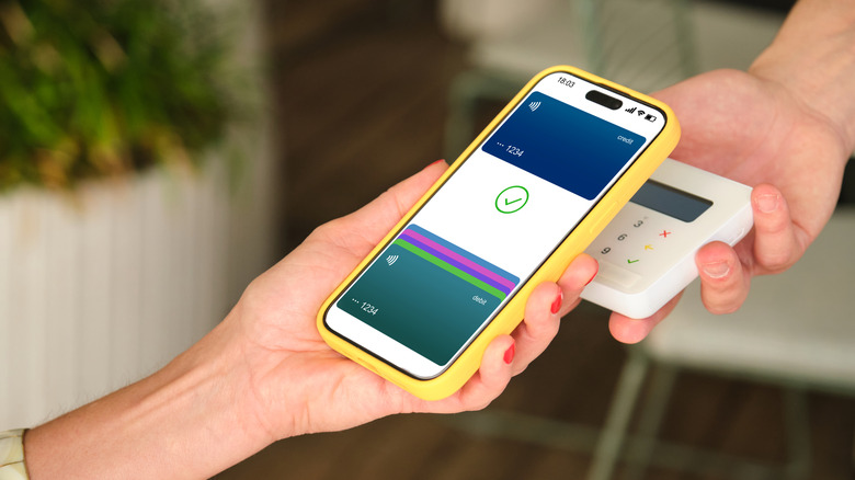 Person paying with a card on their phone