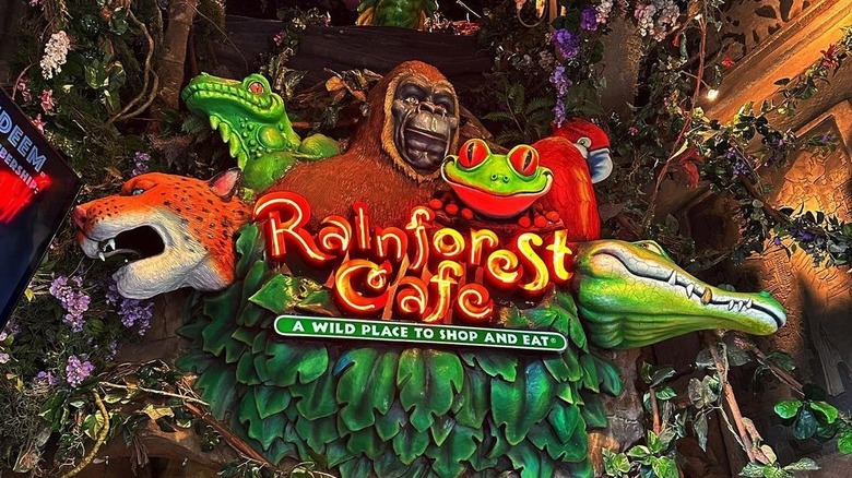 Rainforest cafe sign with animals and greenery