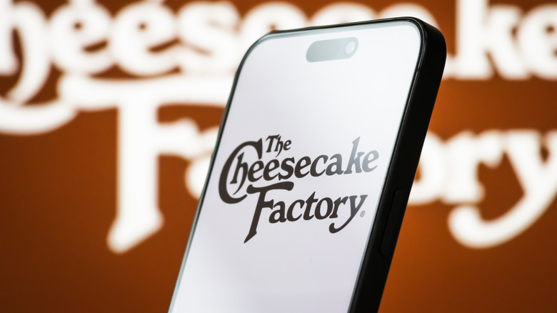 The Cheesecake Factory logo on a phone