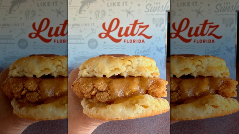 Hand holding honey butter chicken biscuit from Whataburger