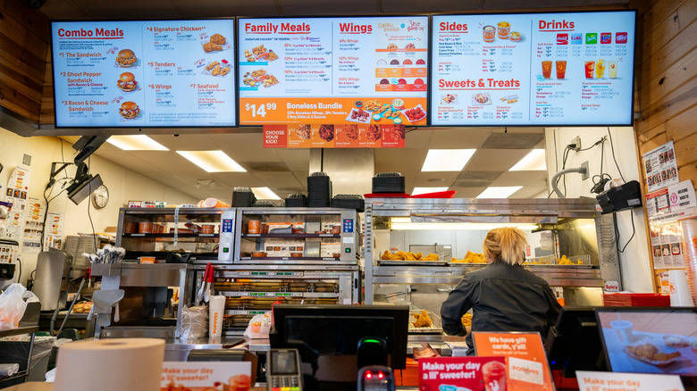 Employee working behind counter at Popeyes