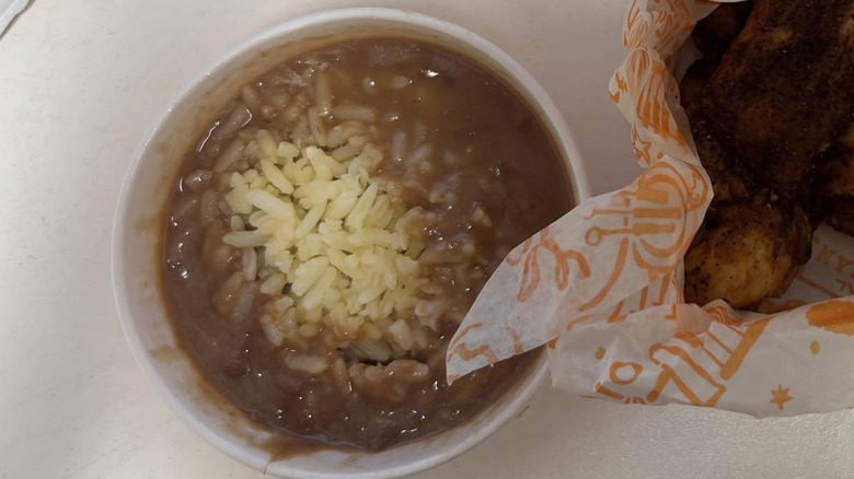 Container of Popeyes red beans and rice