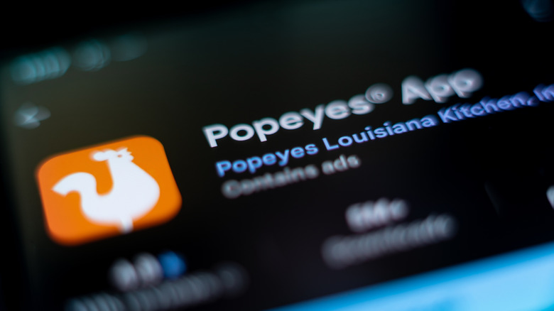 Popeyes app symbol on phone screen