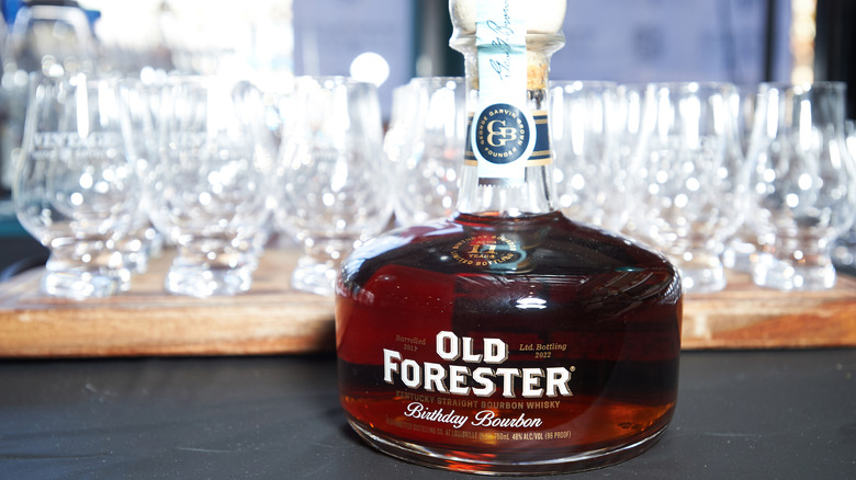 Bottle of Old Forester Birthday Bourbon with Glencairn tasting glasses behind