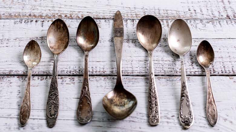 Vintage spoons laid out on wooden table
