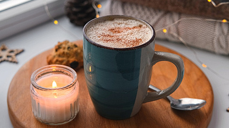 Winter windowsill coffee mug beside blankets