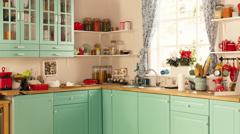 Kitchen with bright mint green cabinetry.