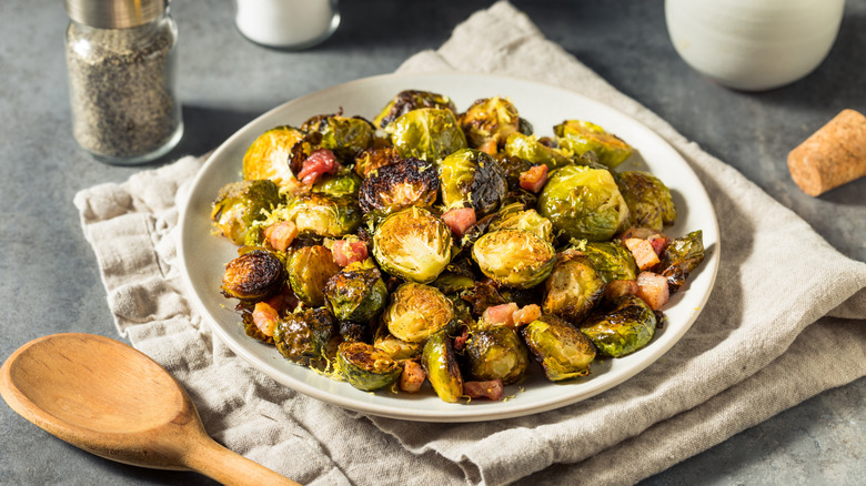 A plate of roasted Brussels sprouts with candied bacon sprinkled in