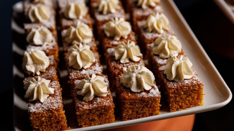 slices of spiced cake on tray with whipped icing