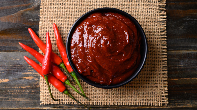 bowl of gochujang next to chiles