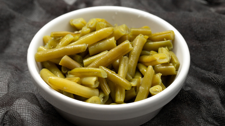 Canned green beans in a white bowl