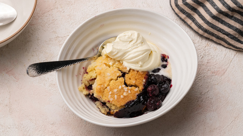 Cherry cobbler with whipped cream