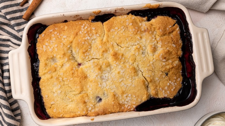 A freshly baked cherry cobbler with a sugar dusted biscuit topping