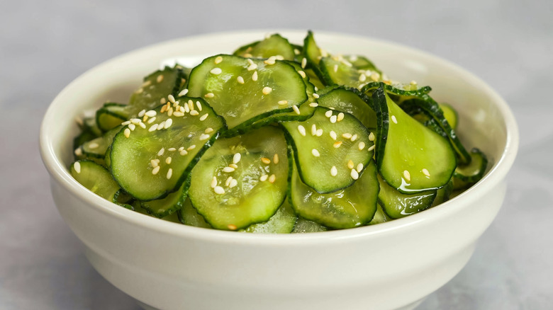 Bowl of cucumbers with sesame seeds