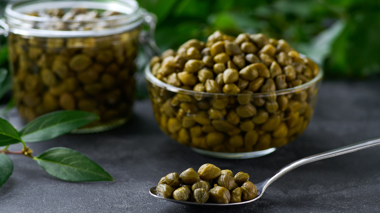 Capers in a spoon and a bowl