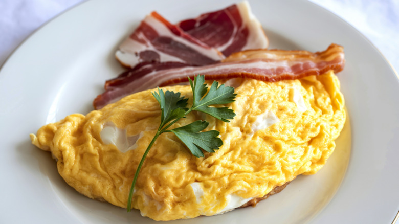 Plain egg omelet with slices of bacon