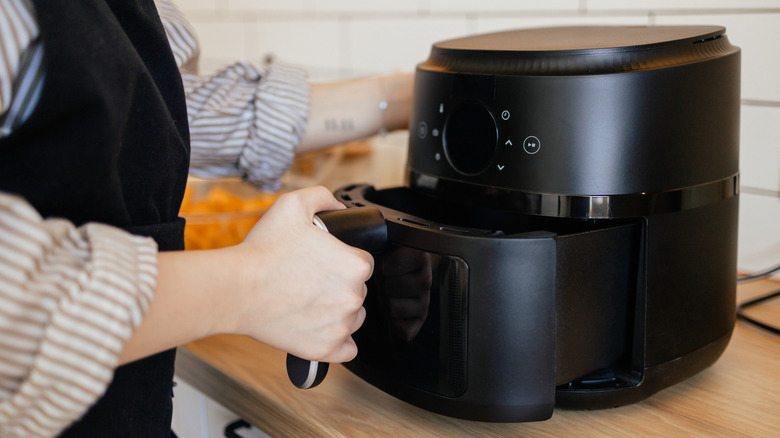 Woman using air fryer