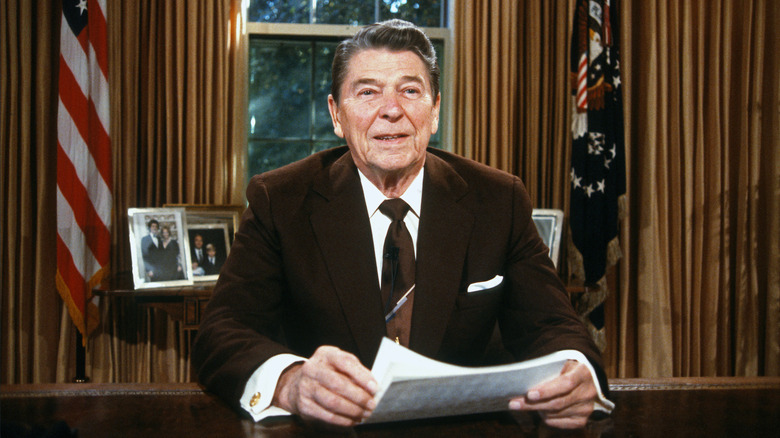 Ronald Reagan sitting at desk