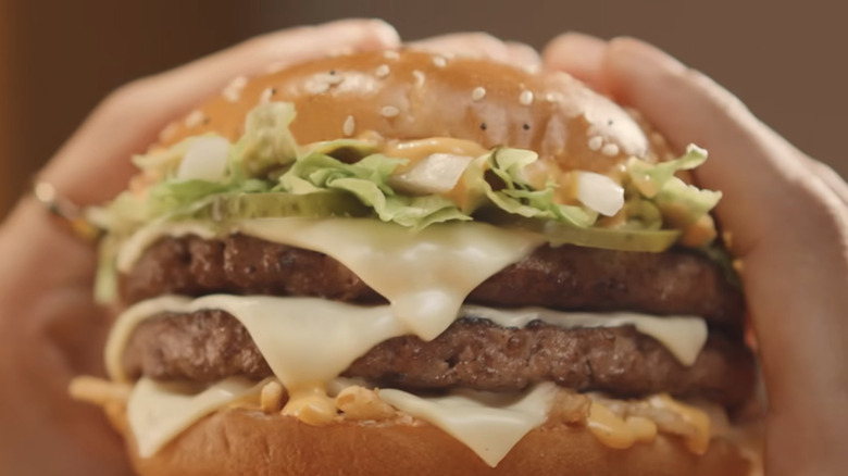 McDonald's Big Arch Burger being held by a customer