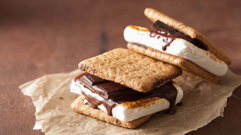 Two s'mores sandwiches on parchment