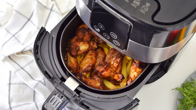 chicken and vegetables inside an air fryer