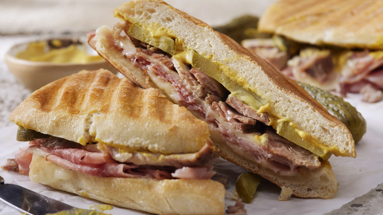 Cuban sandwich stacked with pork, mustard, and cheese
